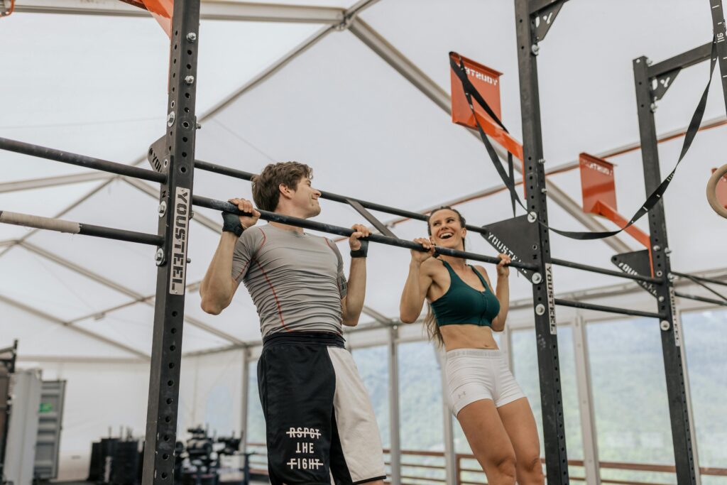 a man and a woman doing pull ups